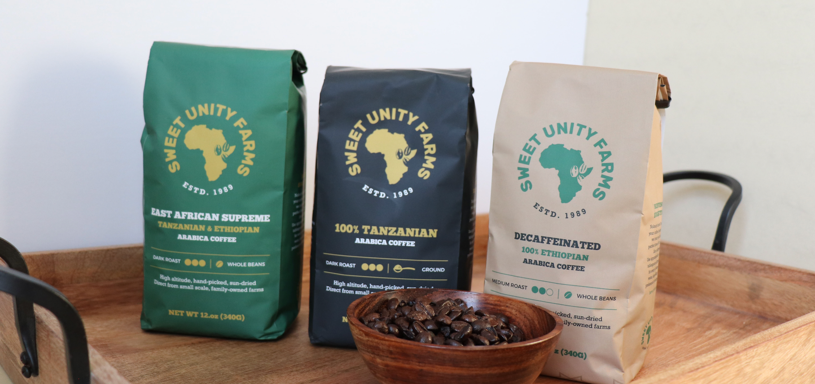 Image of Sweet Unity coffee bags, green, black and tan. 